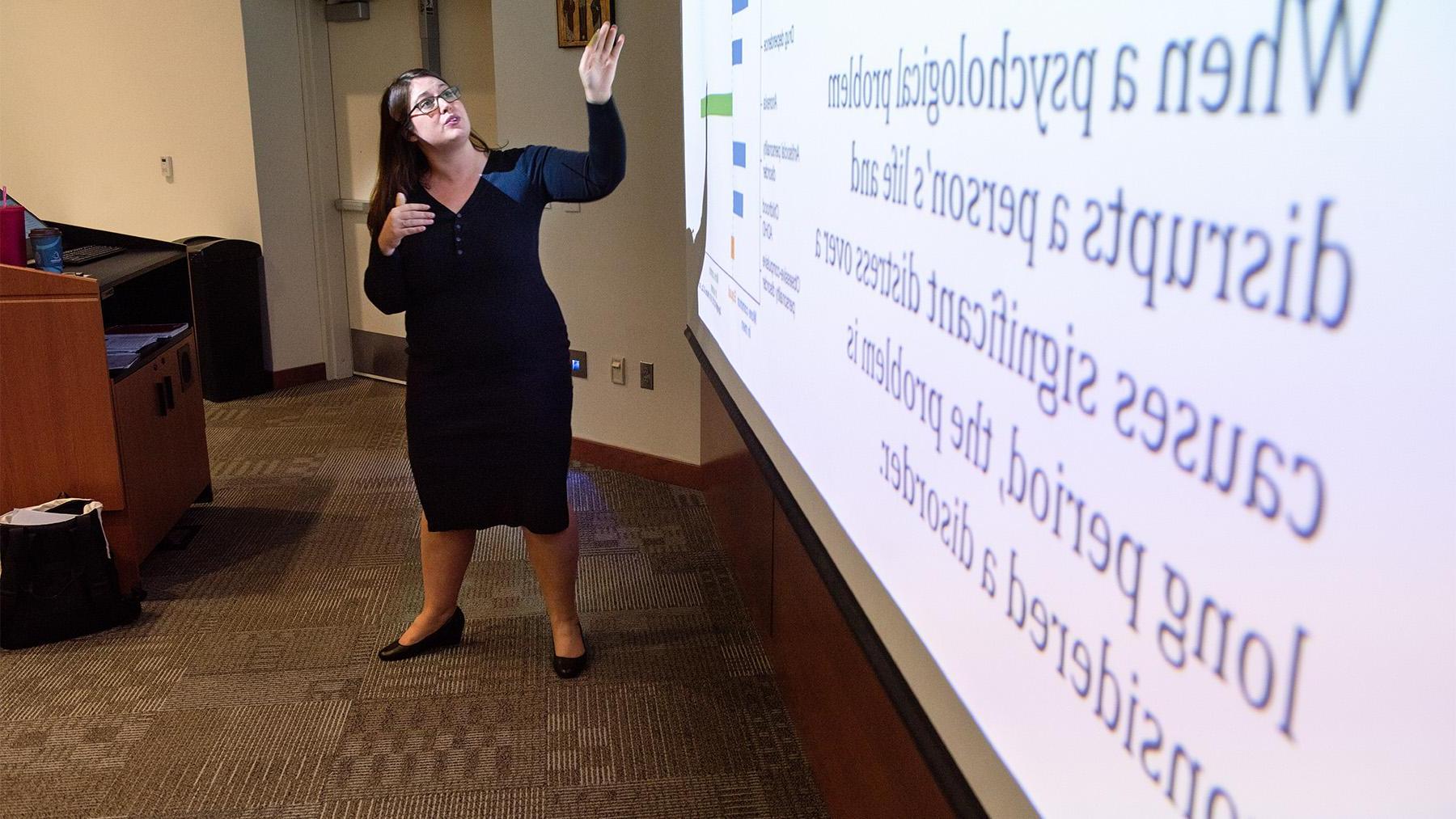 Teacher in a Psychology class showing a slideshow.